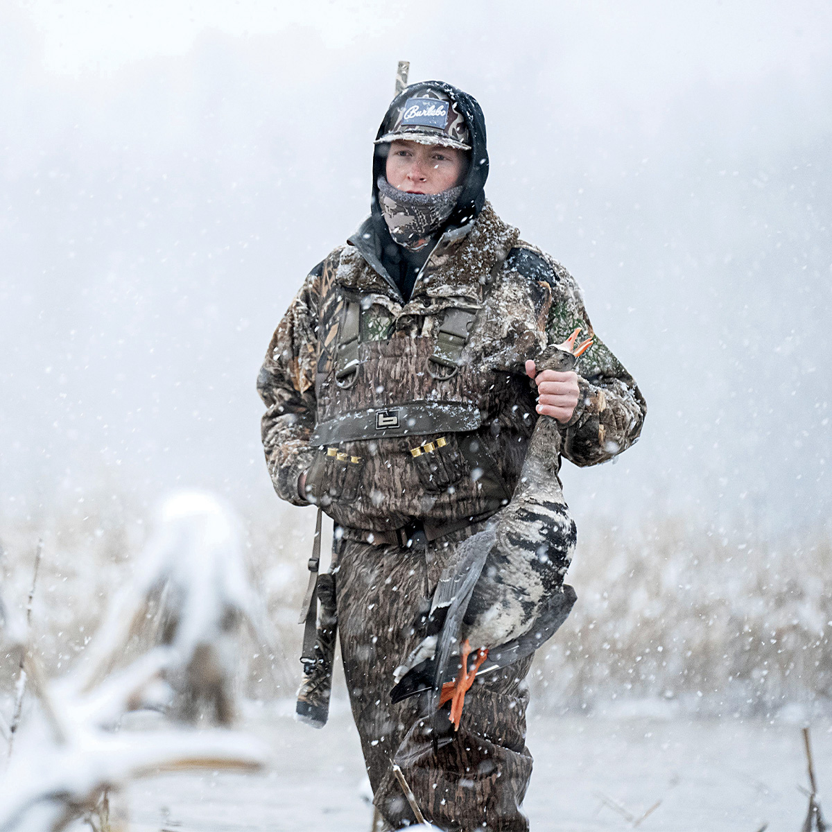 Waterfowl hunter with harvested goose. Photo by Clayton Holmes